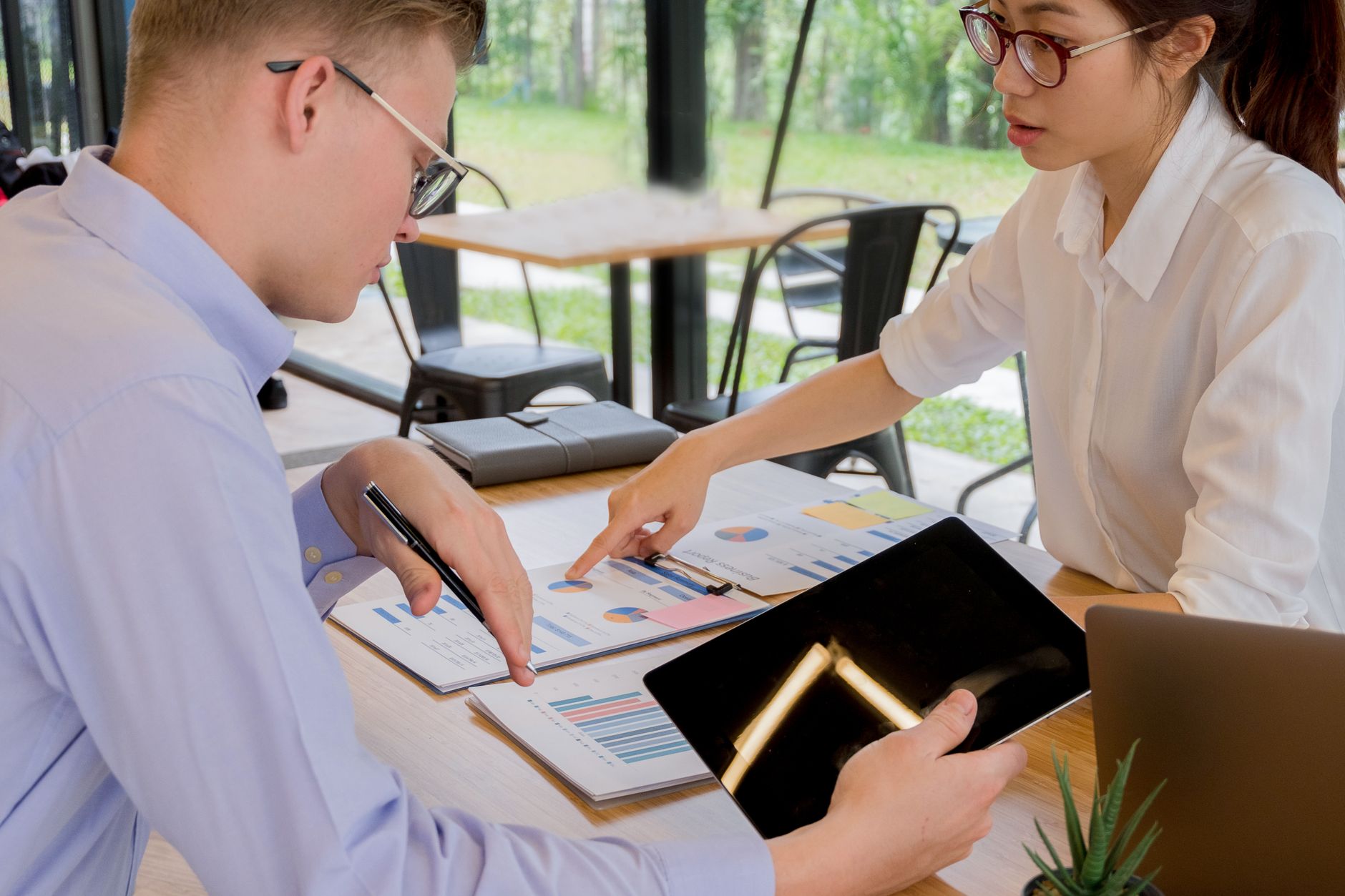 Two colleagues reviewing a working plan